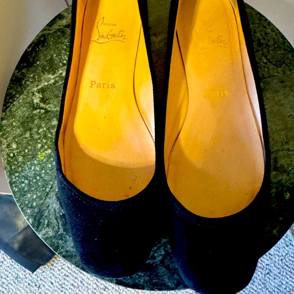 Flat black suede Christian Louboutin flats.